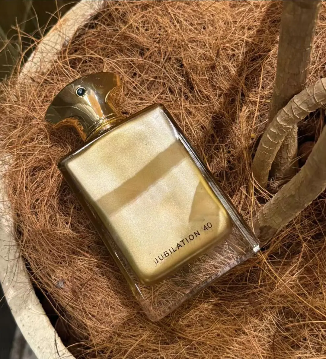 Jubilation 40, a luxurious golden fragrance with rich warm notes. Elegant bottle design, perfect for special occasions, gifts and personal collection.