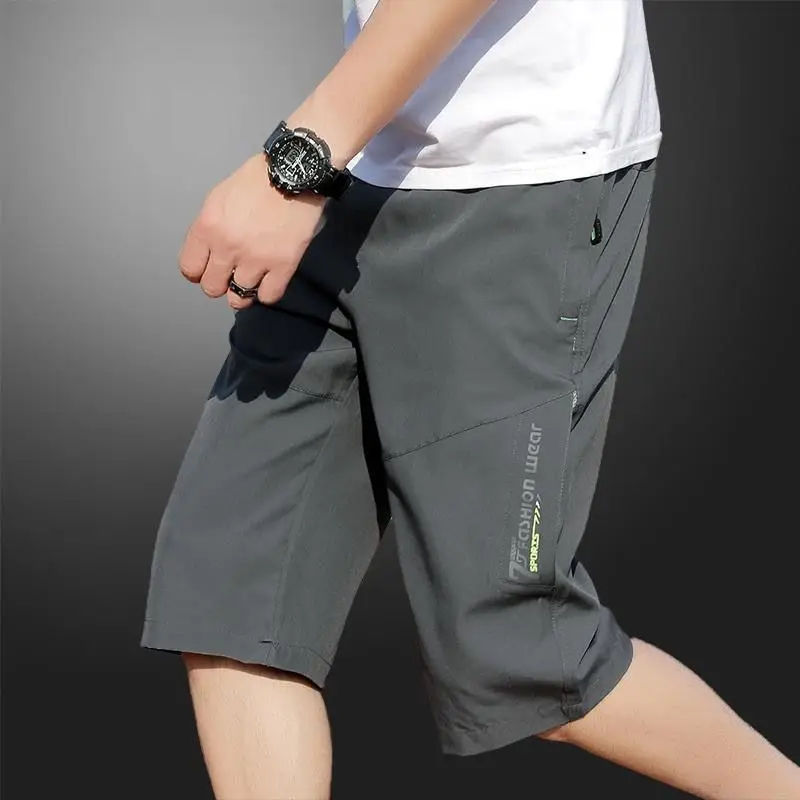 2025 New Men's Seven point Ice Silk Zipper Pocket Casual Pants Breathable Elastic Fabric Slimming Version Summer Outdoor Vacatio