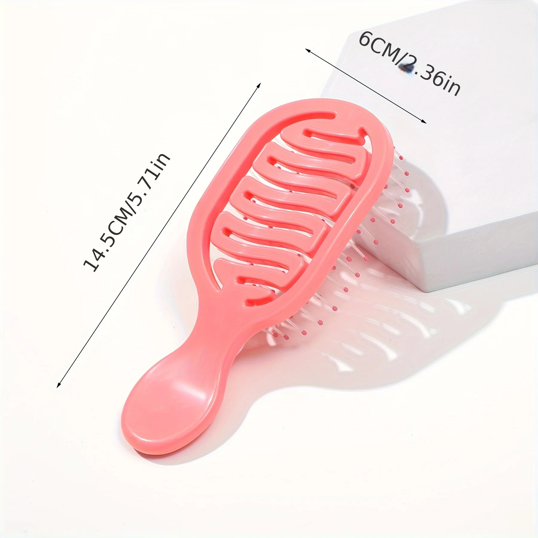 Mini Track Hairbrush, portable hollow design with nylon bristles, ergonomic handle, compact and lightweight—a travel essential.