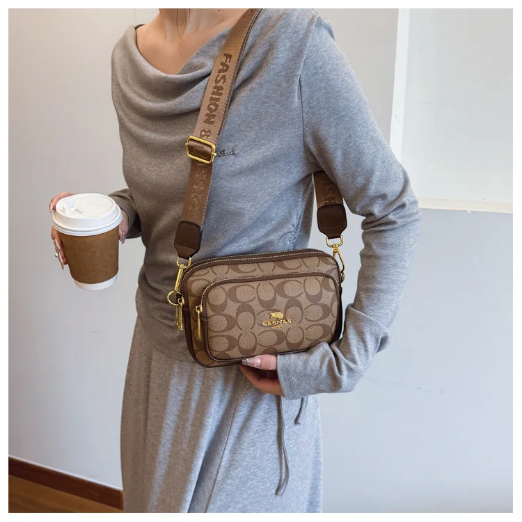 Original Circular-Pattern Logo Crossbody: Retro-luxury, durable fabric, adjustable strap. Ideal for daily/work/social use