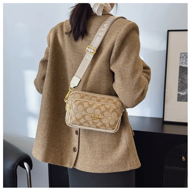 Original Circular-Pattern Logo Crossbody: Retro-luxury, durable fabric, adjustable strap. Ideal for daily/work/social use