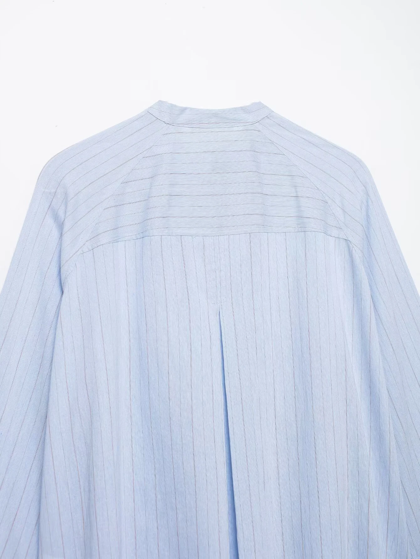 Spring and summer new women's clothing French round neck long sleeved asymmetrical hem flip chest pocket striped shirt