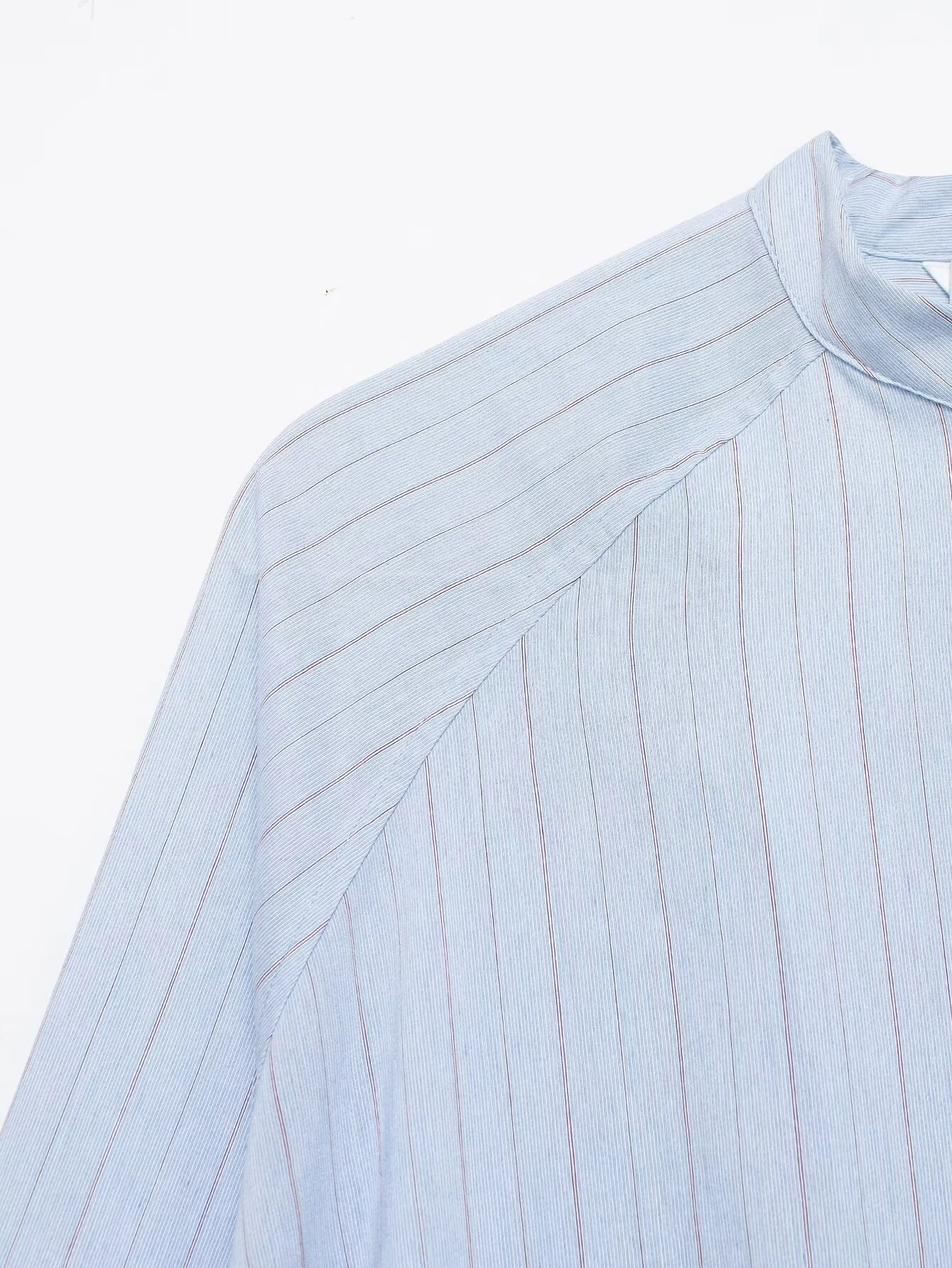 Spring and summer new women's clothing French round neck long sleeved asymmetrical hem flip chest pocket striped shirt