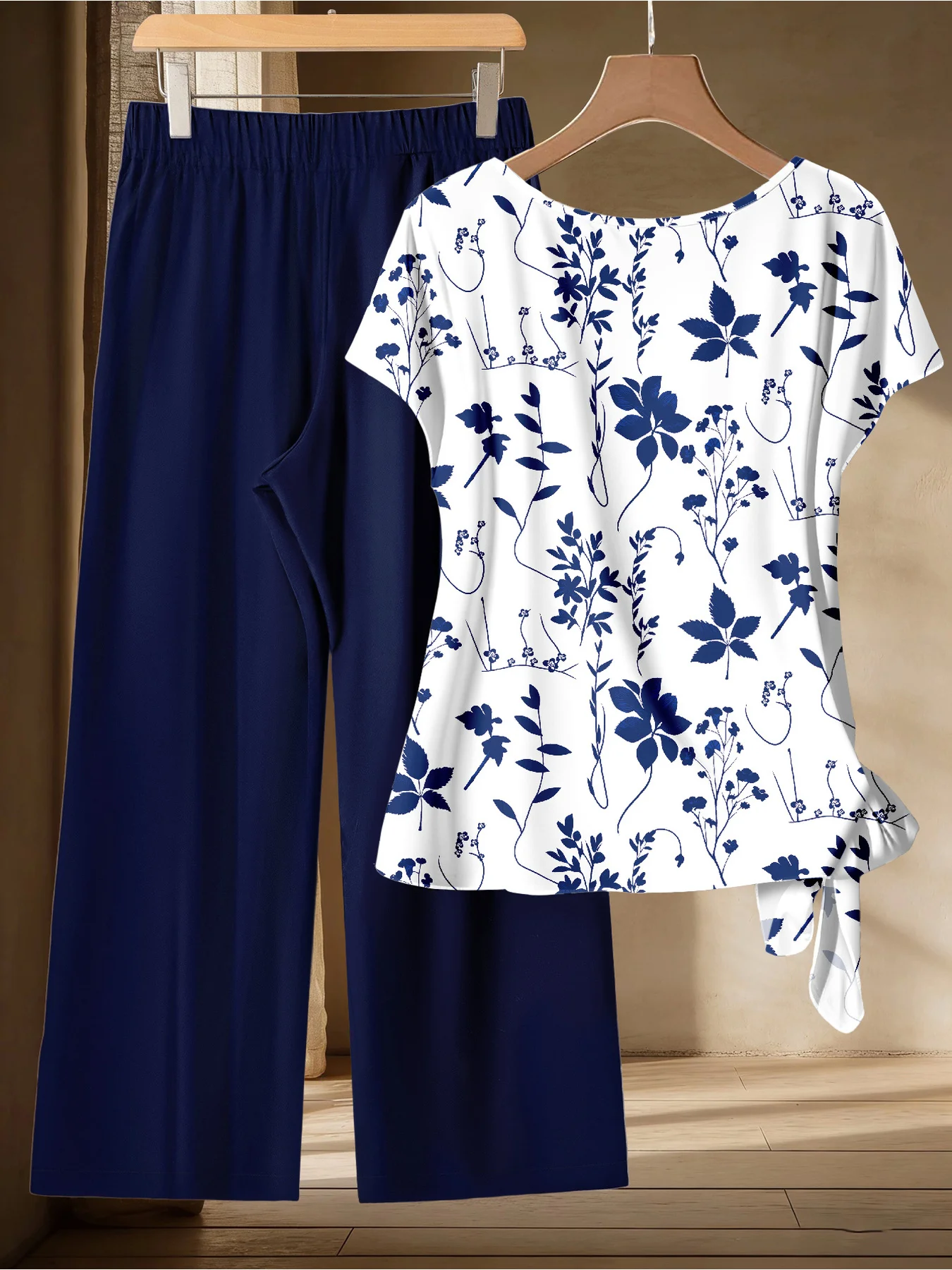 Summer Comfortable and Casual Women's Plus Size White Plant Pattern Twisted Top, Navy Blue Wide Leg Pants Set, Two-Piece Set