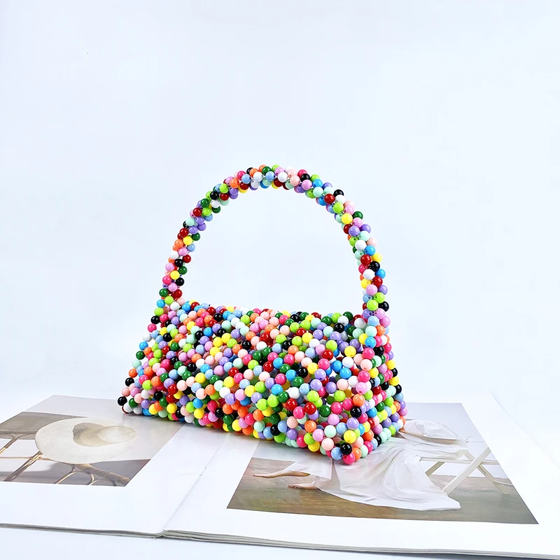 European and American same niche handmade color-blocked pearl triangle bag, fashionable and versatile hand-held bead bag