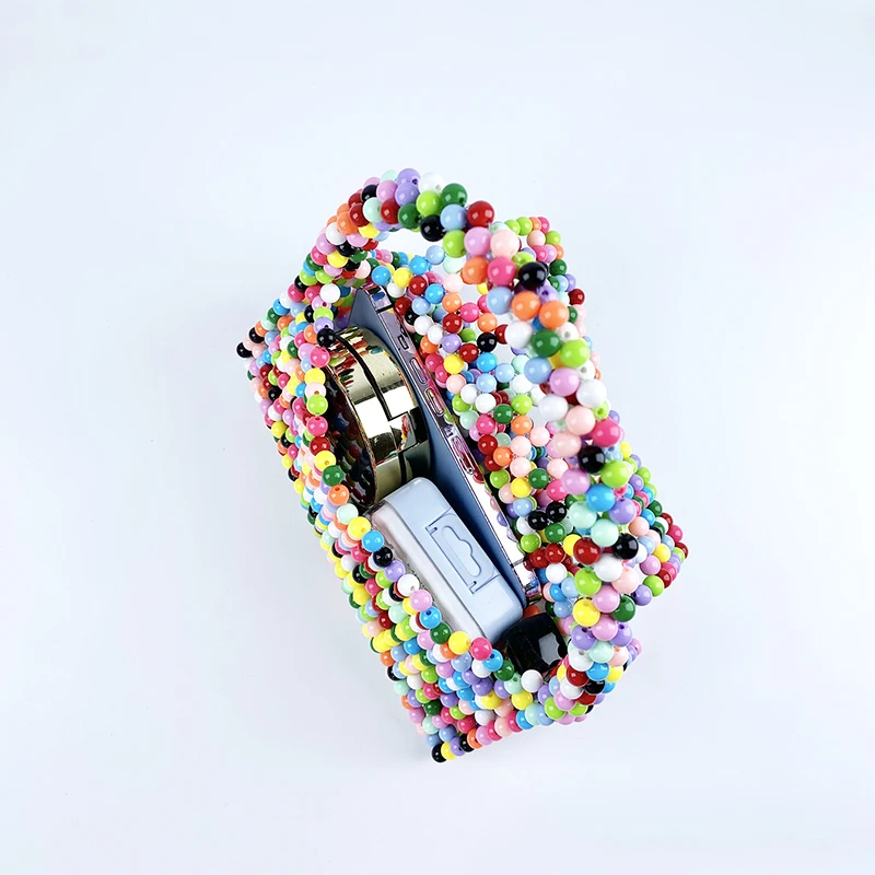 European and American same niche handmade color-blocked pearl triangle bag, fashionable and versatile hand-held bead bag