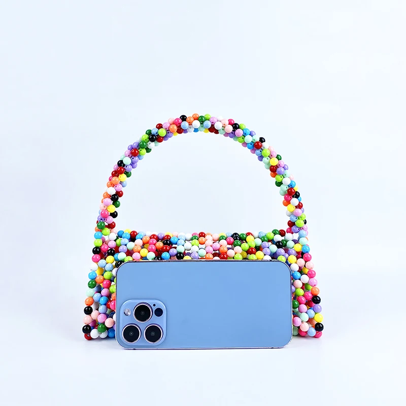 European and American same niche handmade color-blocked pearl triangle bag, fashionable and versatile hand-held bead bag