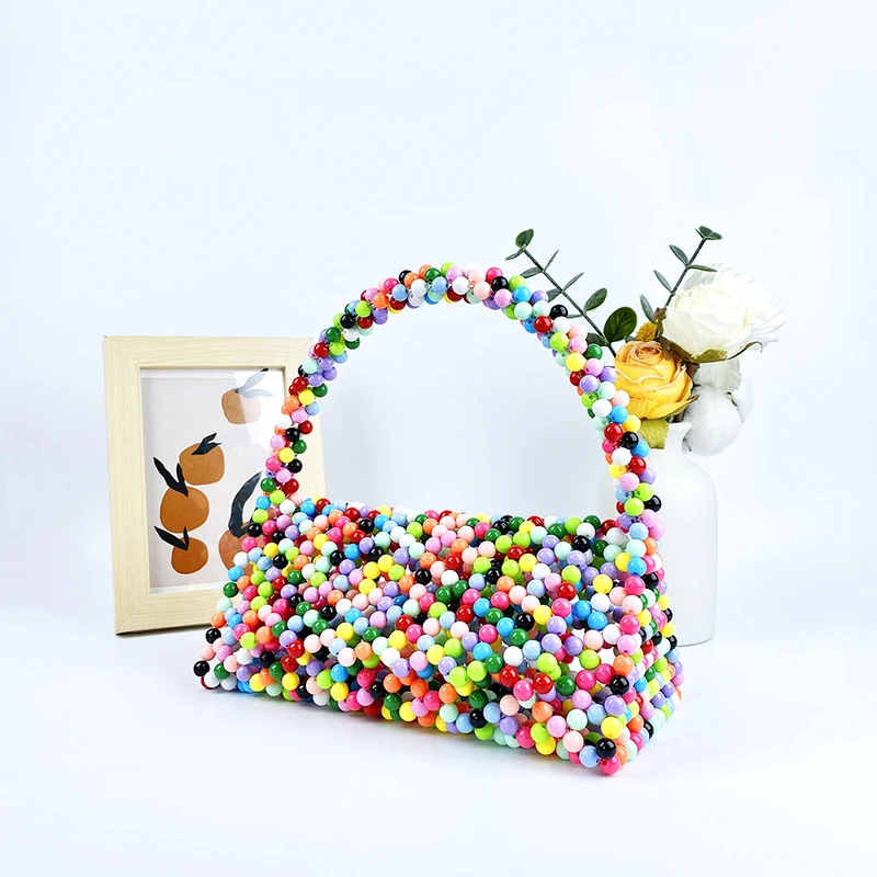European and American same niche handmade color-blocked pearl triangle bag, fashionable and versatile hand-held bead bag