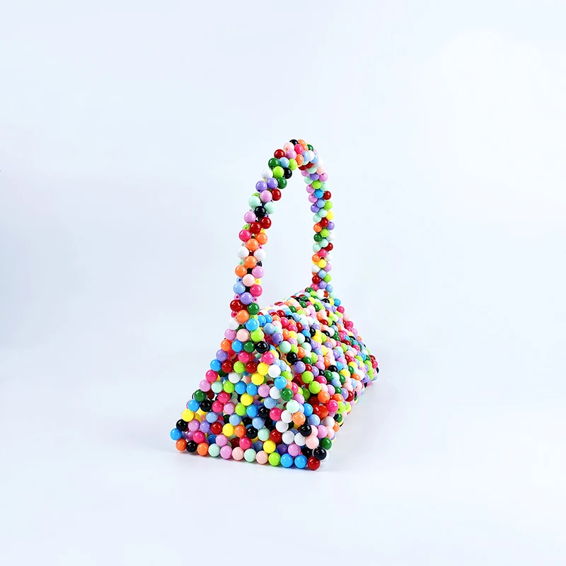 European and American same niche handmade color-blocked pearl triangle bag, fashionable and versatile hand-held bead bag