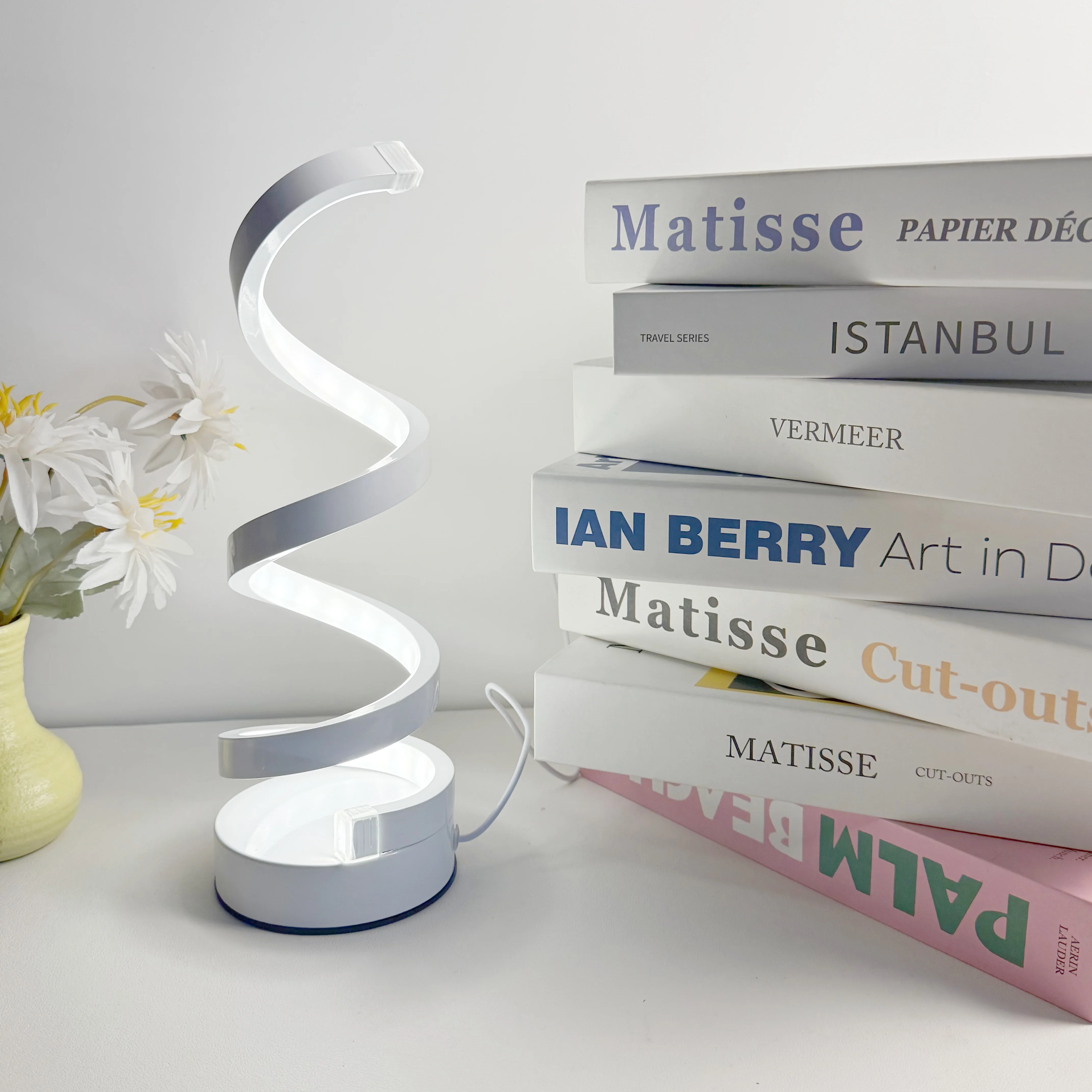 A Modern, Elegant White Spiral Desktop Lamp, Powered by USB with Three-Color Dimming, Suitable for Various Types of Rooms.