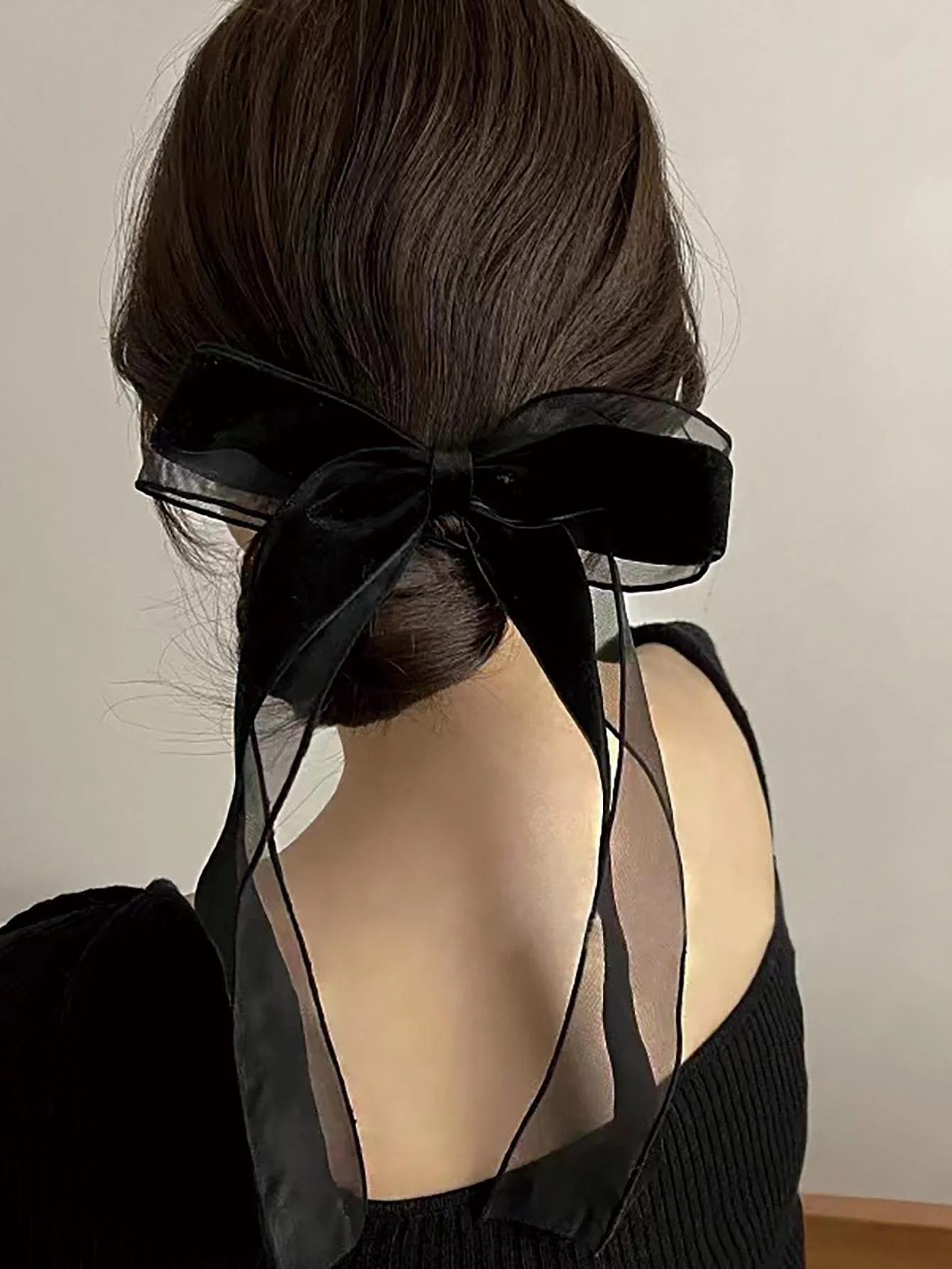 A piece of elegant velvet netting hair accessory featuring double bow hairpins for ladies, suitable for formal events.