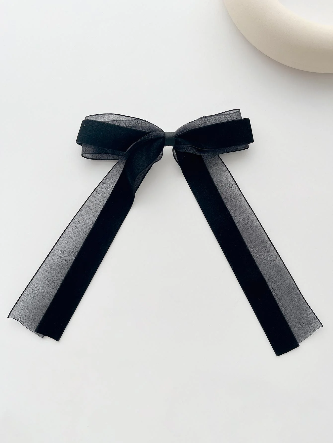 A piece of elegant velvet netting hair accessory featuring double bow hairpins for ladies, suitable for formal events.