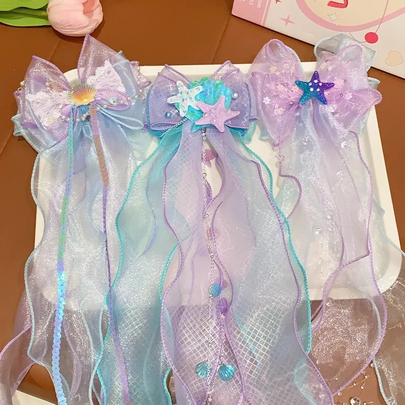 A mermaid princess bow hair clip with a floating gauze pair for a birthday performance hair accessory and veil