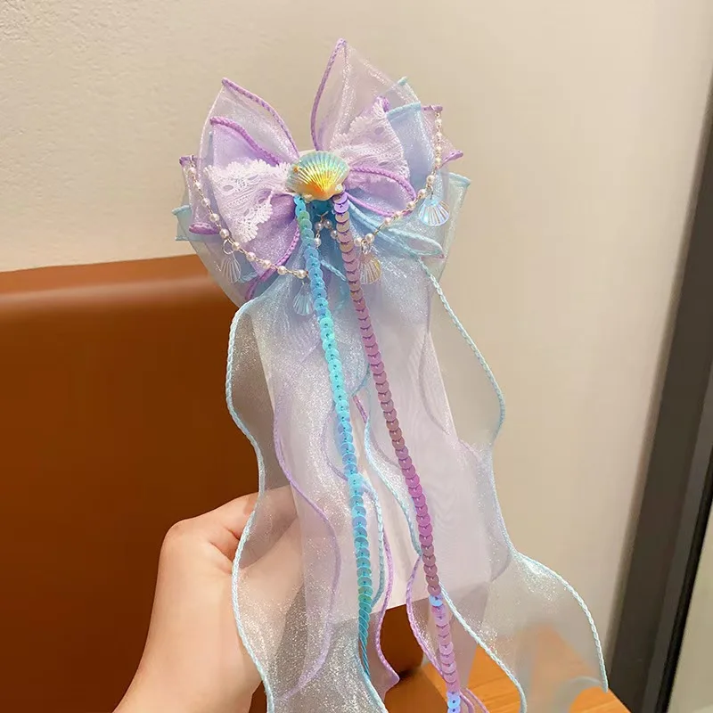 A mermaid princess bow hair clip with a floating gauze pair for a birthday performance hair accessory and veil