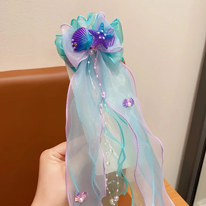 A mermaid princess bow hair clip with a floating gauze pair for a birthday performance hair accessory and veil