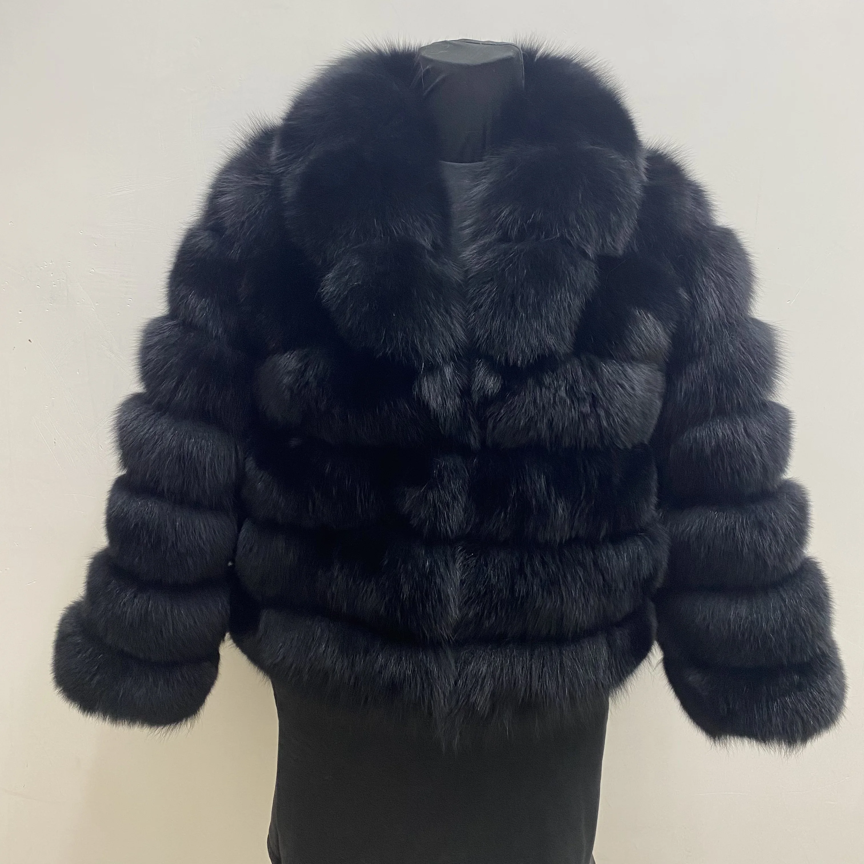 Lady's fashionable warm natural fur coat with a collar for warmth, luxurious high street outerwear