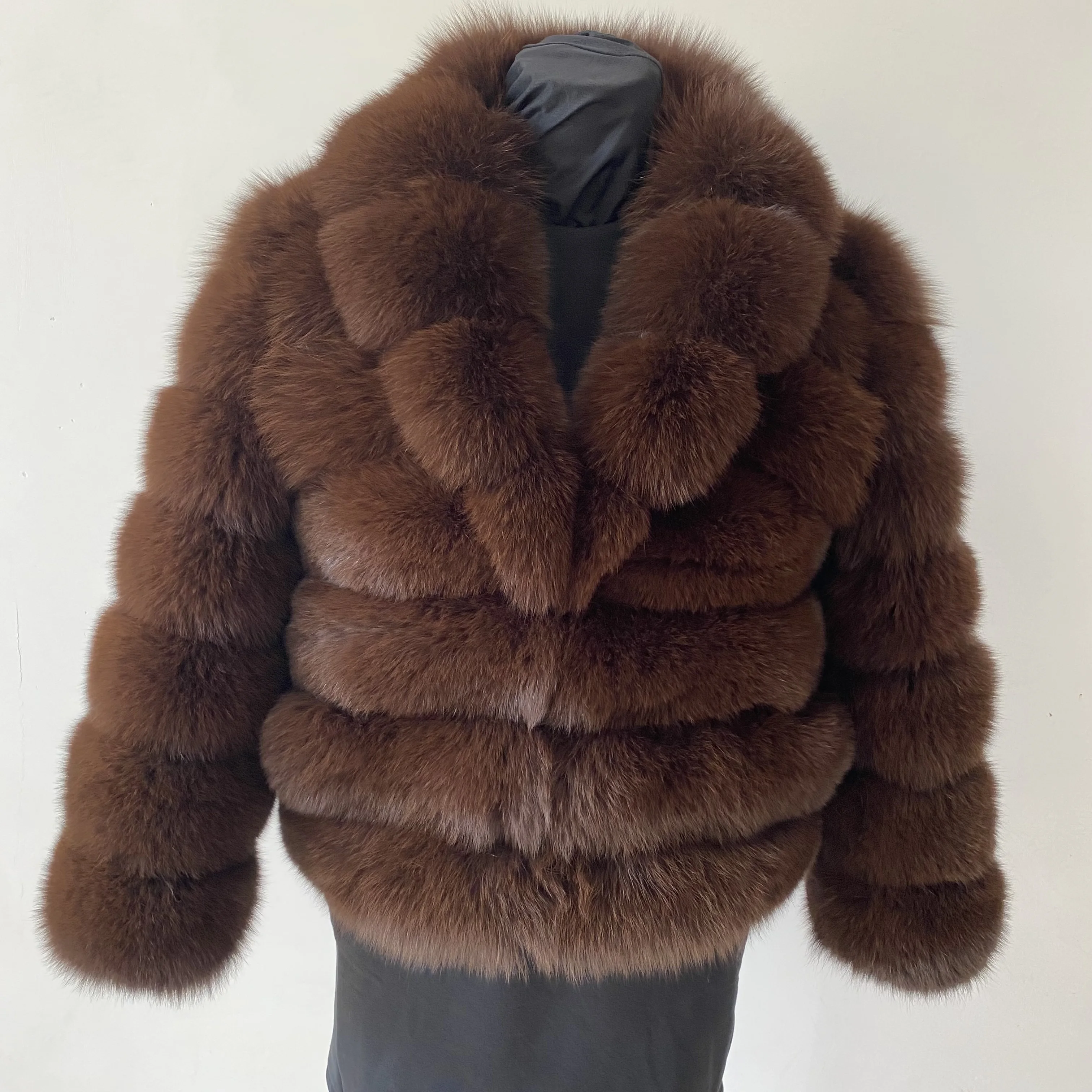 Lady's fashionable warm natural fur coat with a collar for warmth, luxurious high street outerwear